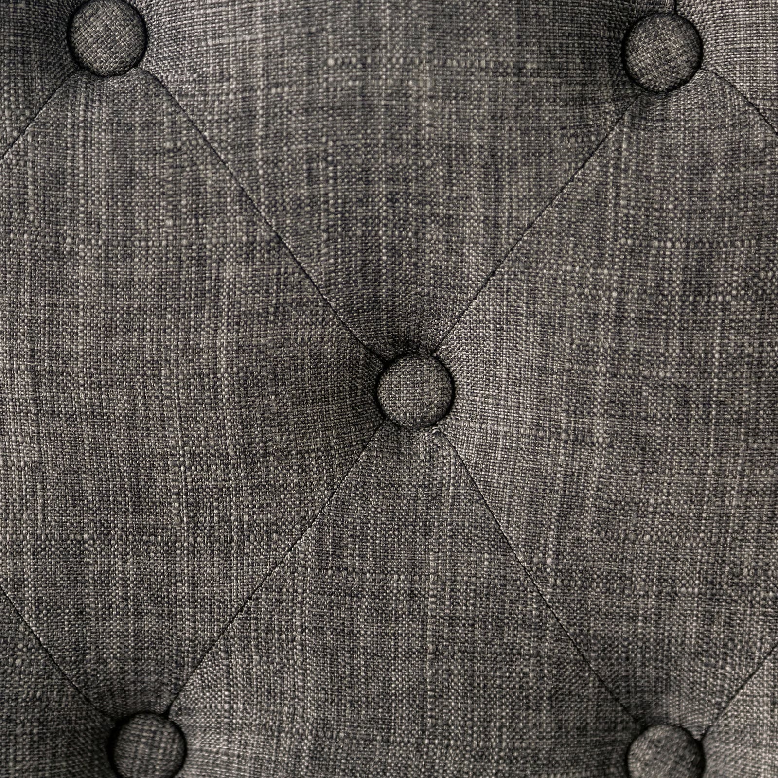 Grey textured fabric with diamond tufted pattern and buttons