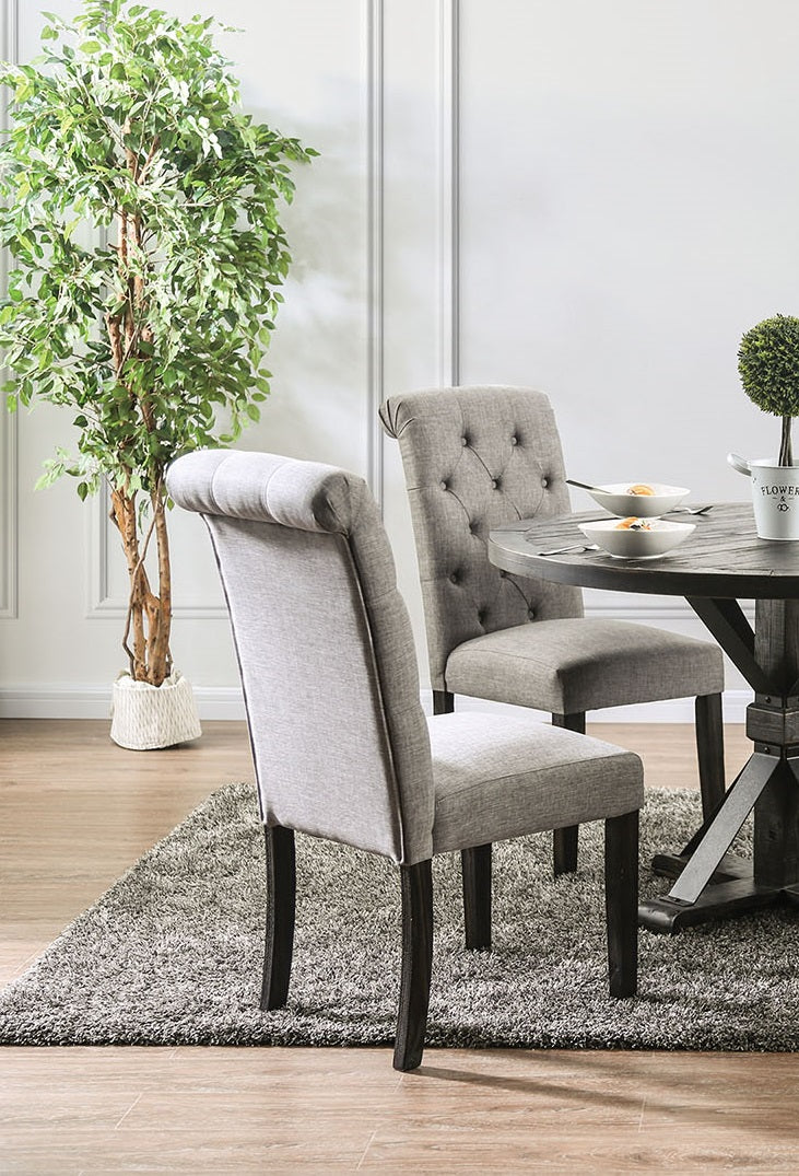 Grey upholstered dining chair with tufted back and dark wood legs
