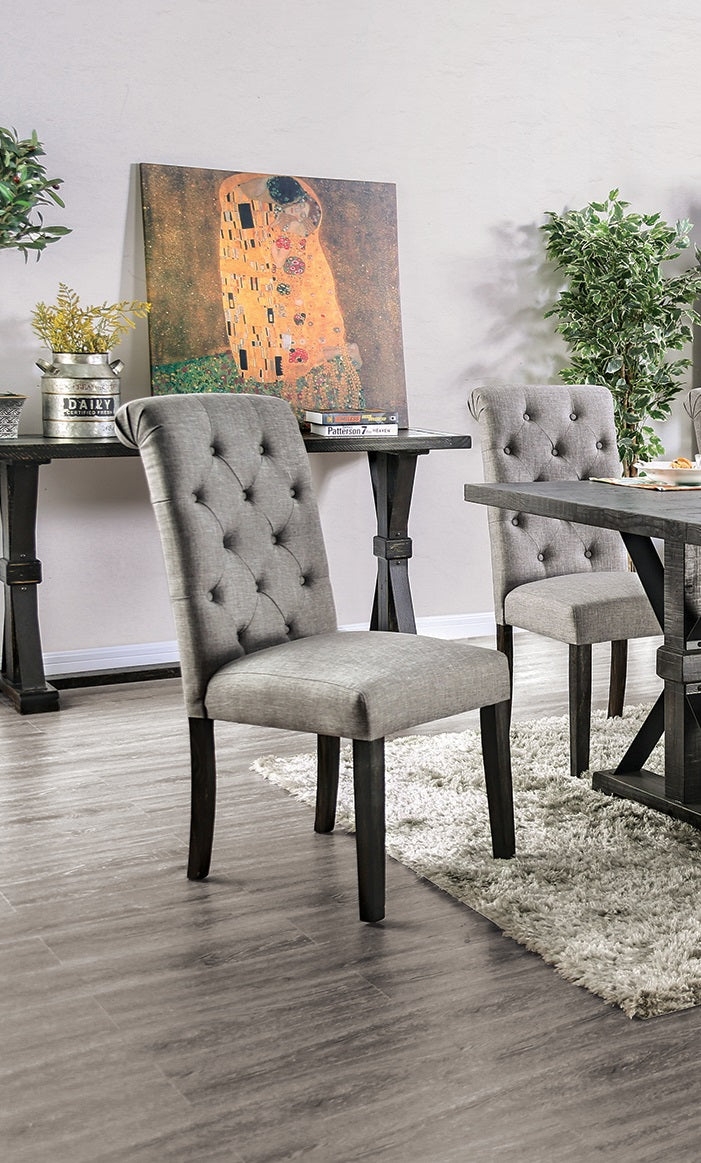 Gray upholstered dining chair with button tufting and dark wood legs