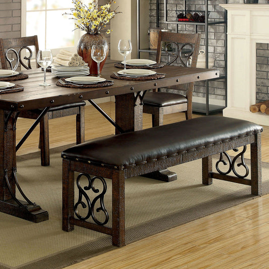 Rustic dark wood dining bench with brown faux leather seat and ornate metal accents