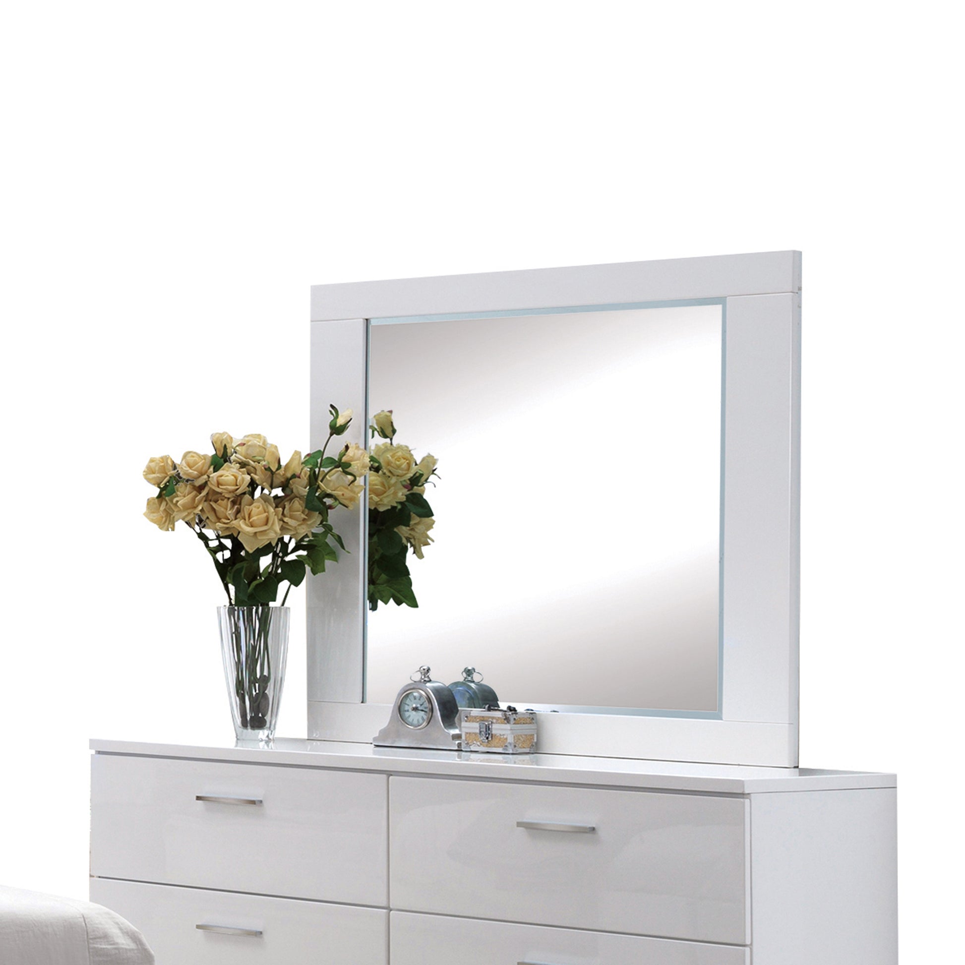 Modern white dresser with mirrored top and silver drawer pulls featuring a bouquet of yellow roses