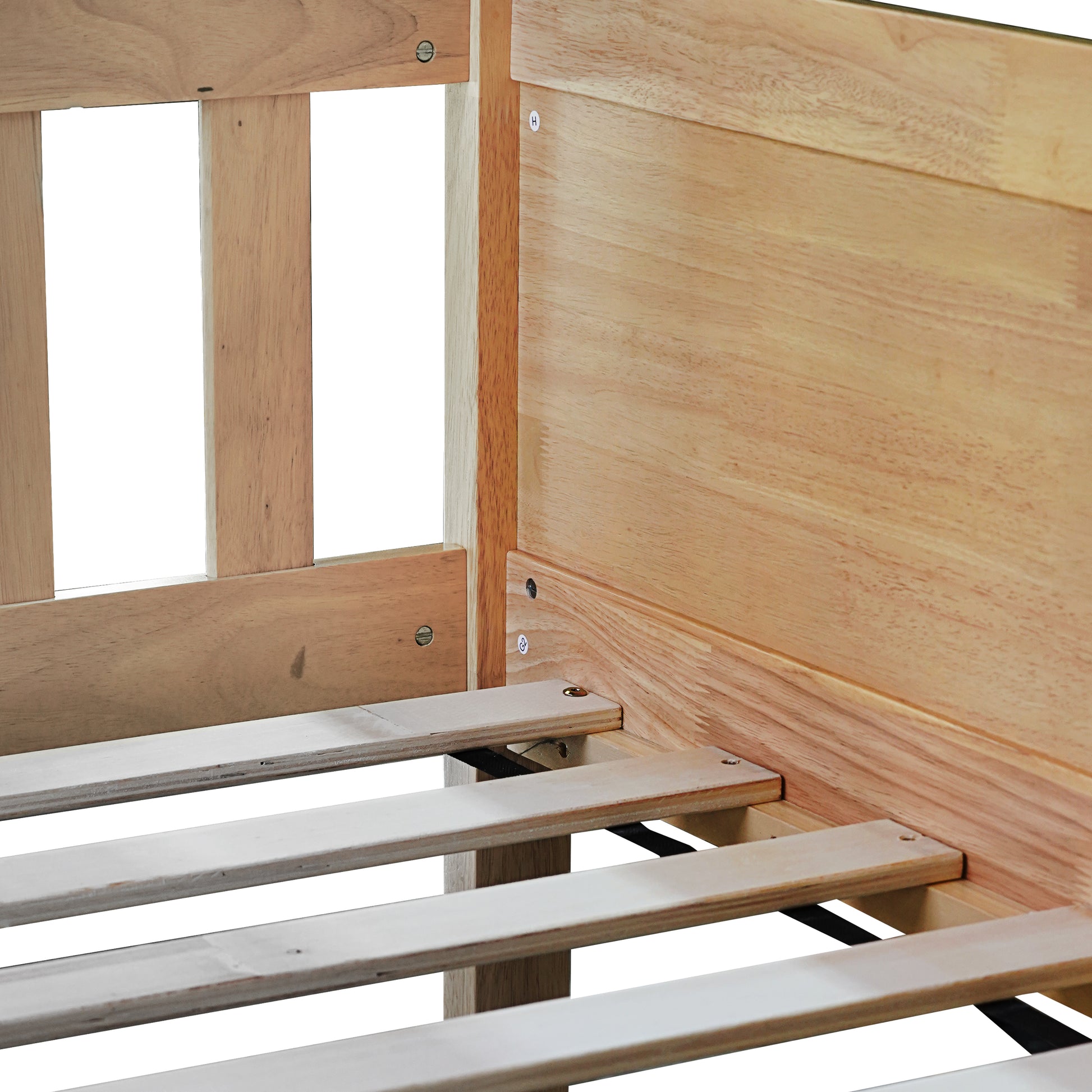 Closeup of light wood bed frame with slatted base