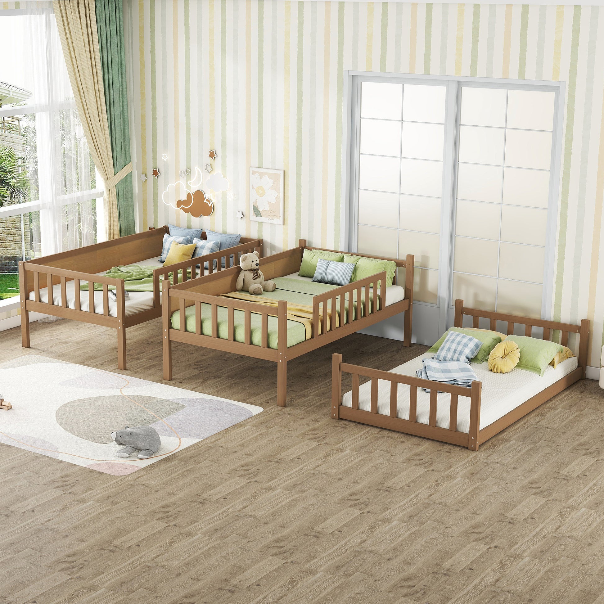Three brown wooden toddler beds with guardrails dressed in green bedding in a childs room