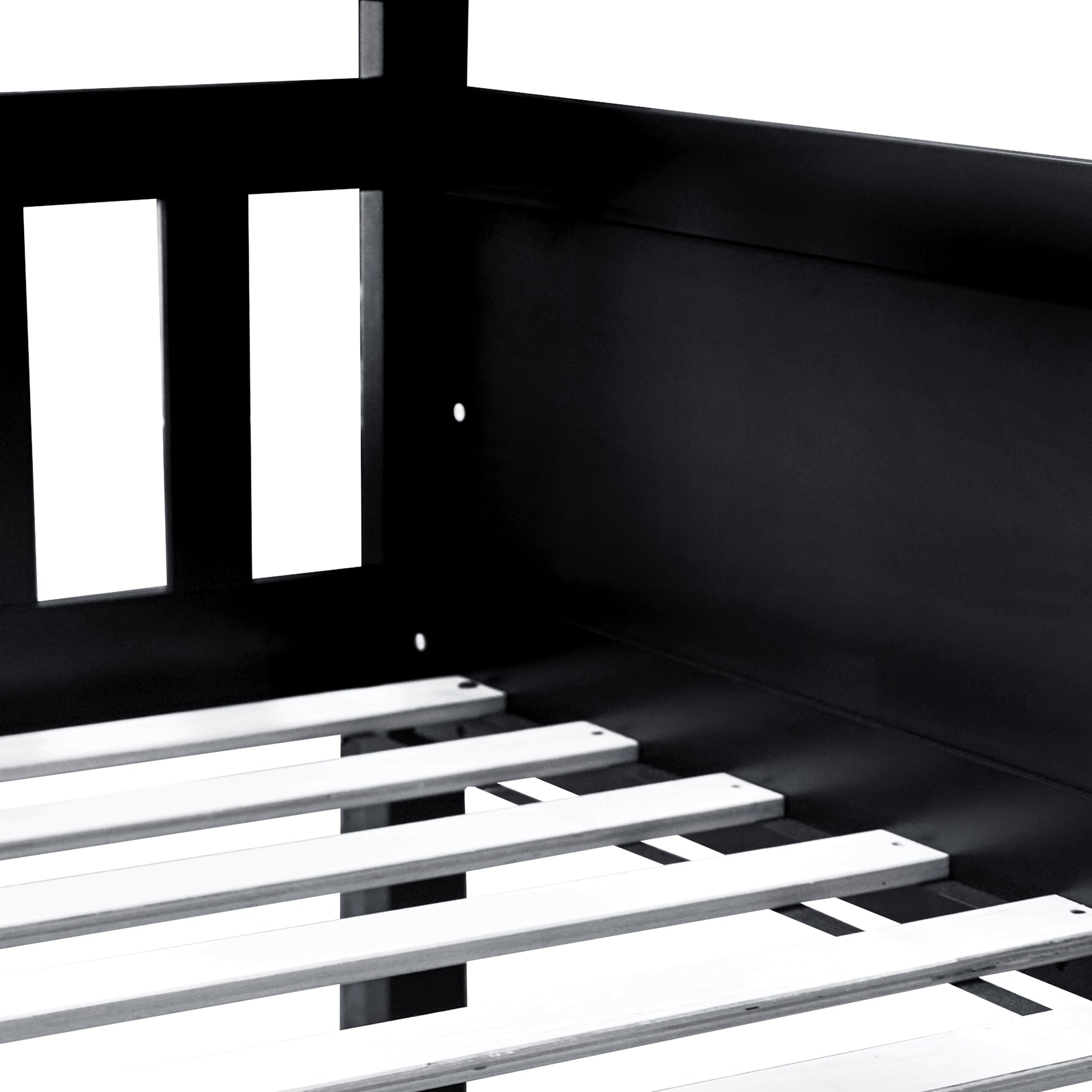 Black metal bed frame detail with slatted base for mattress support