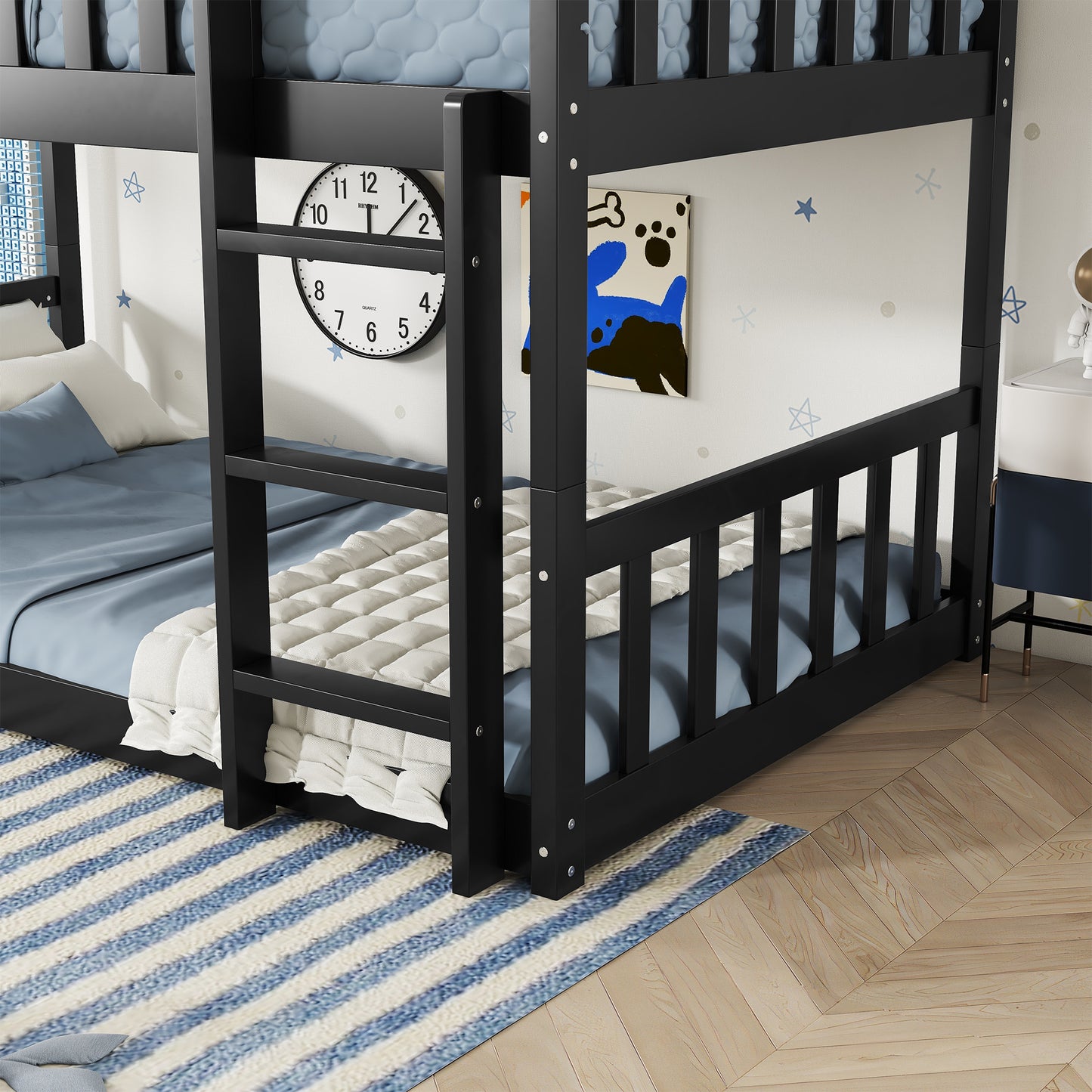 Black wooden bunk bed with blue bedding and white quilt