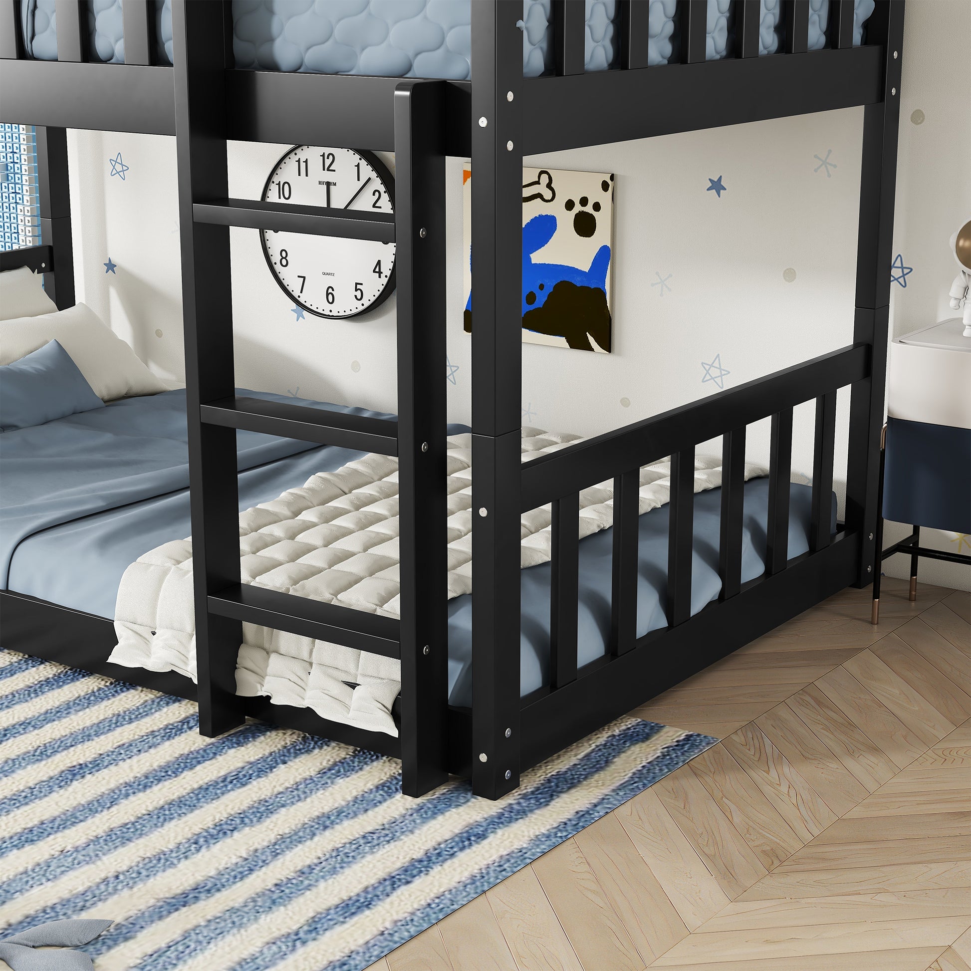 Black wooden bunk bed with blue bedding and white quilt