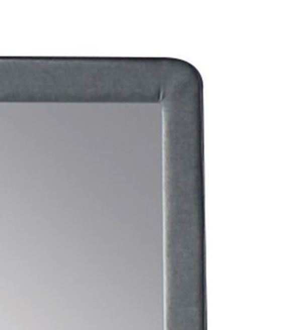 Closeup of a gray velvet framed mirror corner