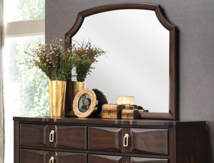 Dark brown wood dresser with ornate arched mirror