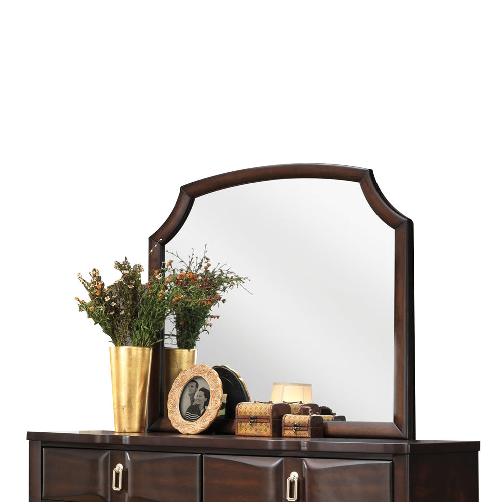 Antique dark wood dresser with ornate arched mirror and decorative accents