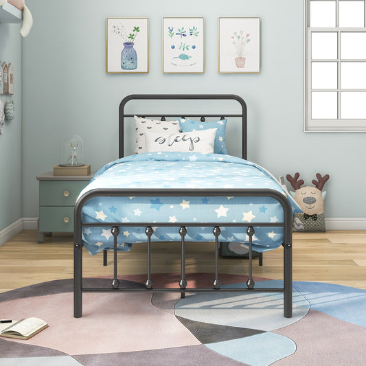 Black metal twin bed with blue star bedding and decorative pillows