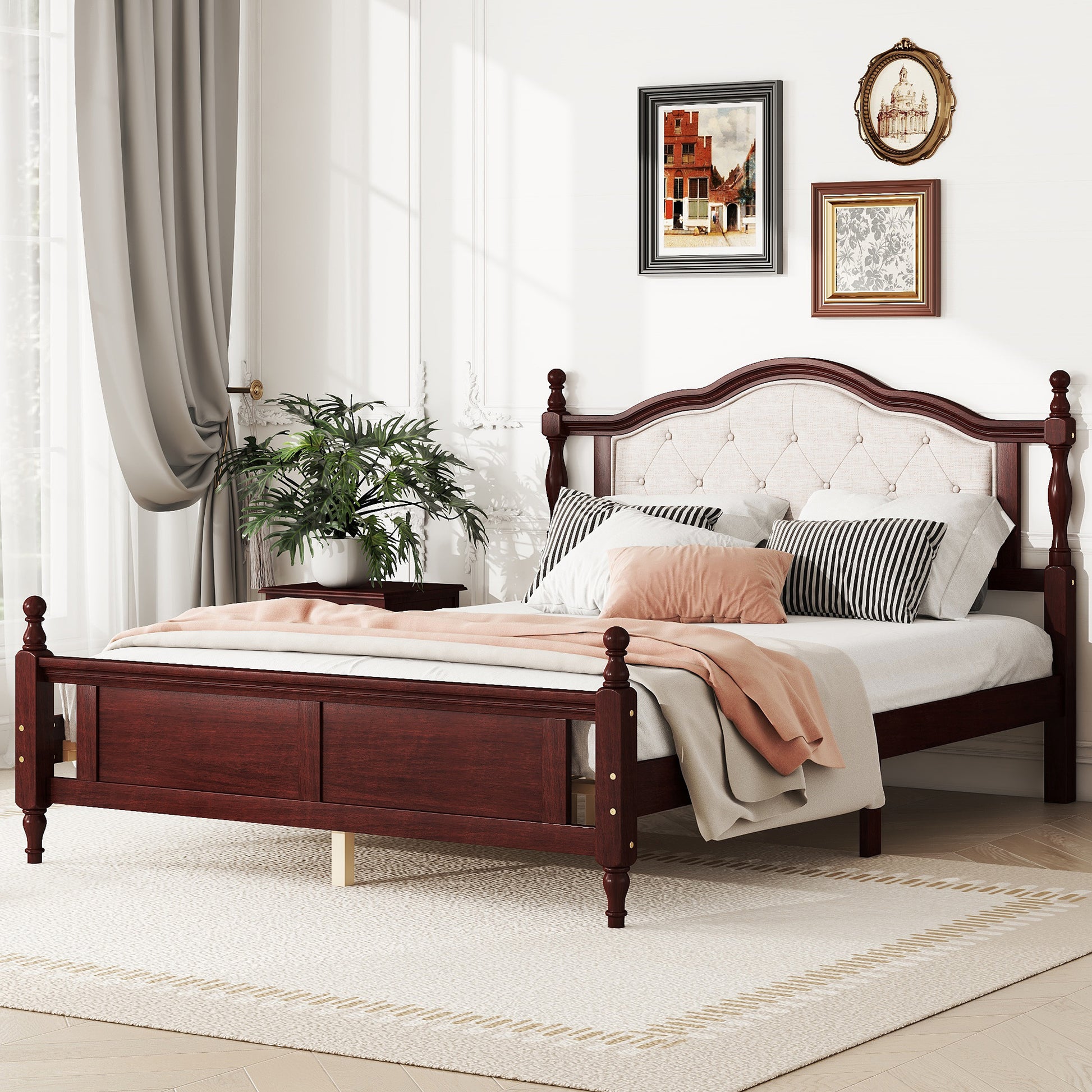 Dark cherry wood bed frame with tufted beige headboard and decorative finials