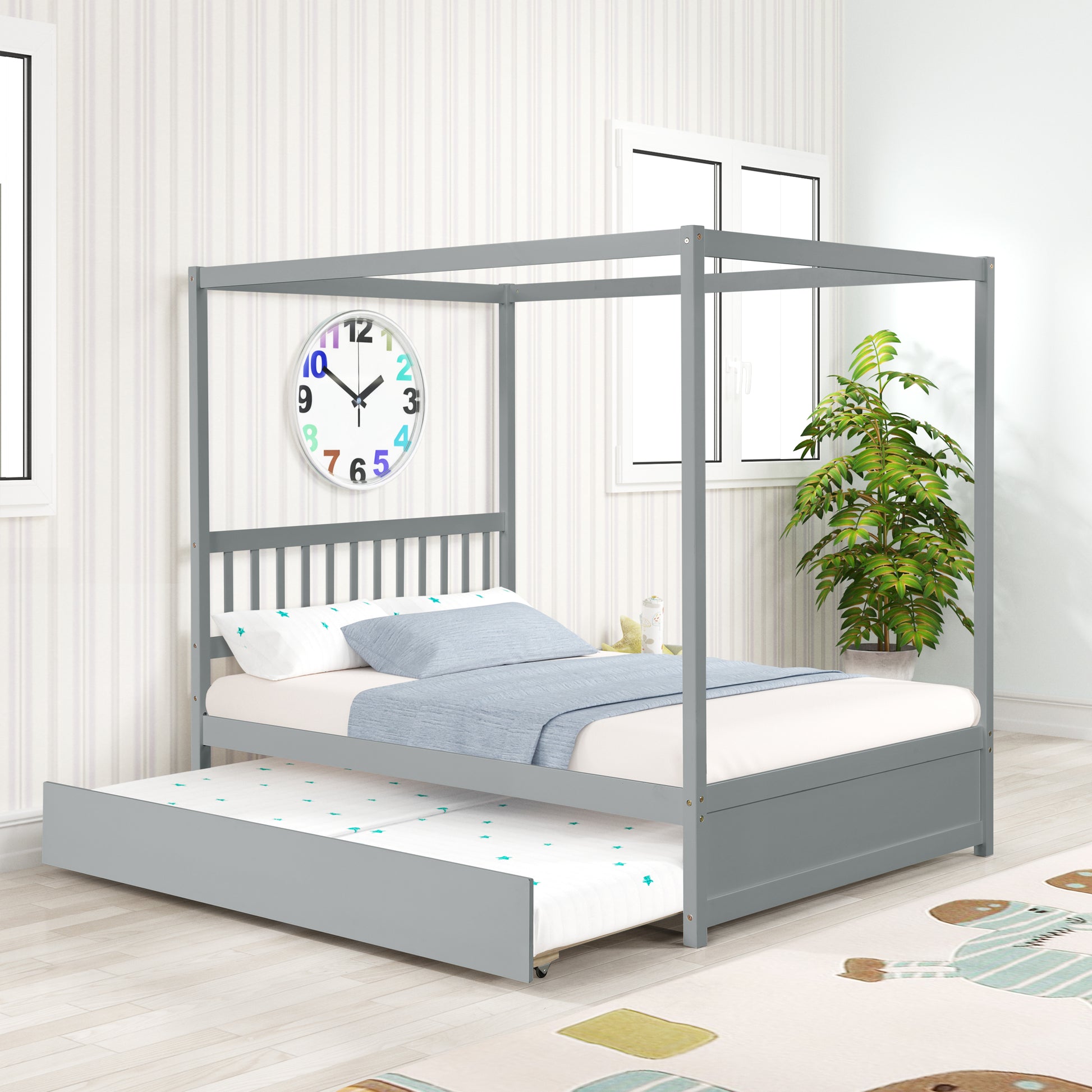 Grey wood canopy bed with a pullout trundle