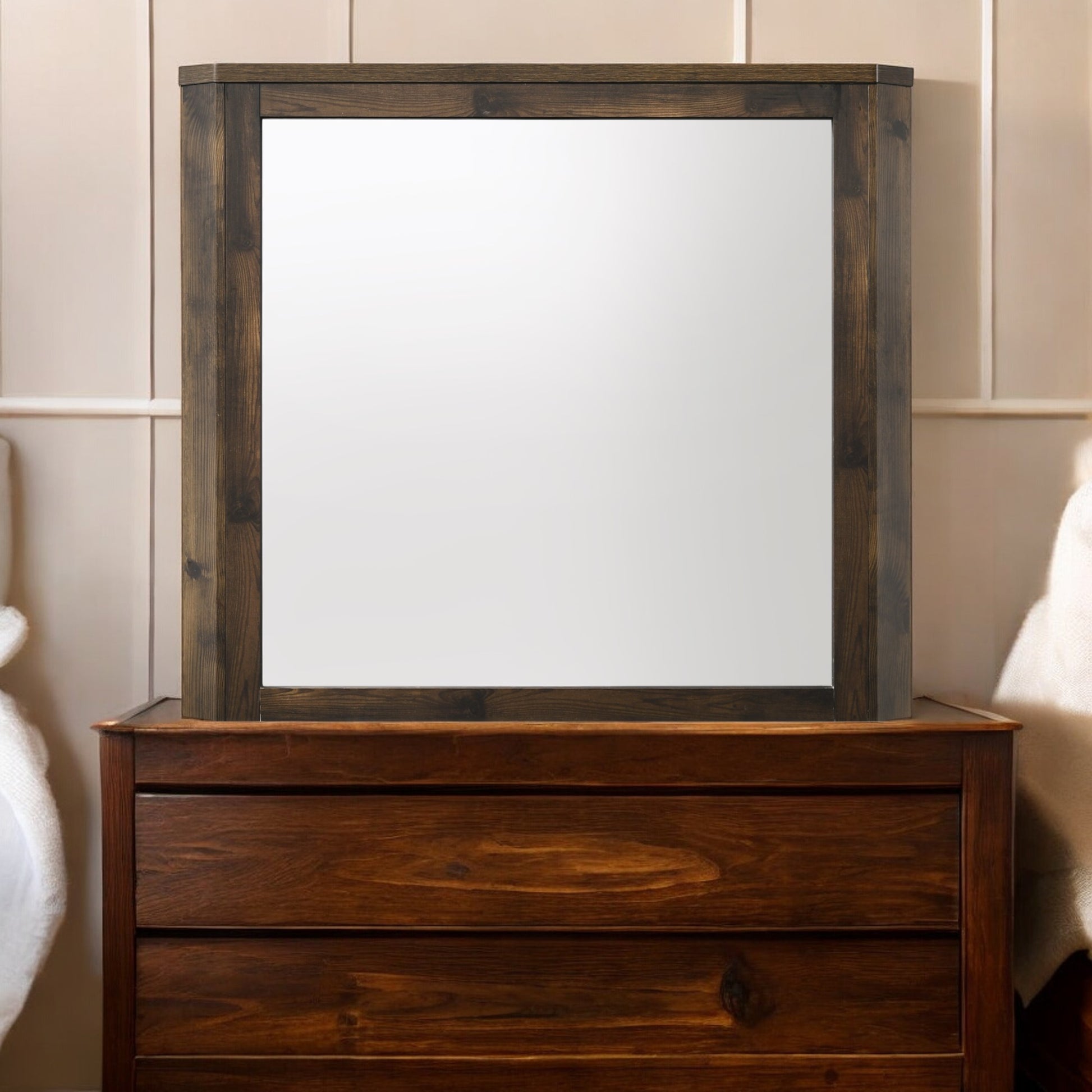 Dark wood framed mirror atop a rich brown wooden dresser