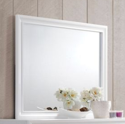 White framed decorative mirror reflecting white flowers on shelf