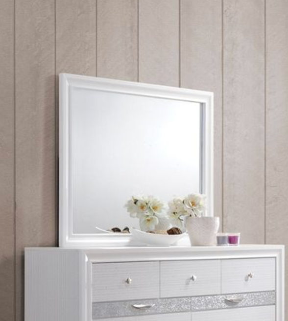White framed dresser mirror reflecting flowers