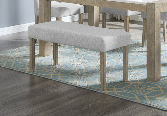 Grey upholstered dining bench with natural wood legs