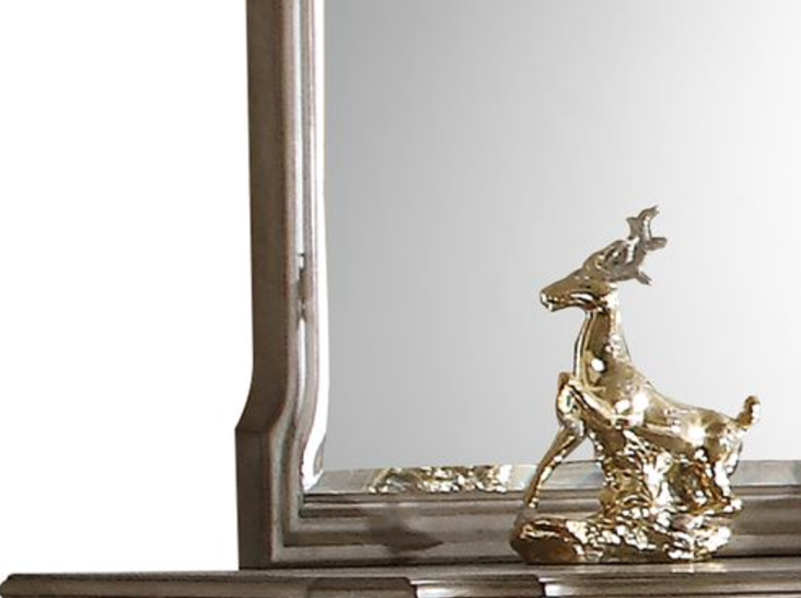 Golden deer figurine on a mirrored surface