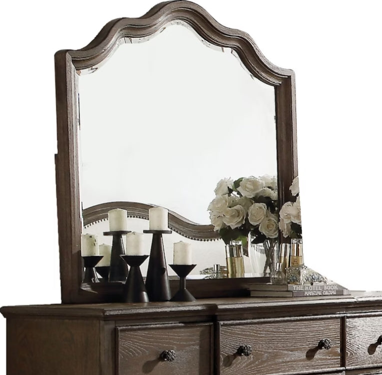 Ornate arched dresser mirror with distressed wood frame