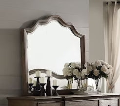 Ornate distressed wood frame wall mirror with scalloped top edge
