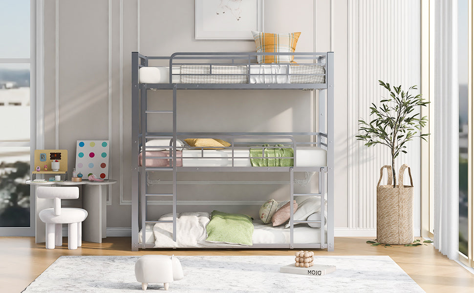 Gray metal triple bunk bed with mattresses and decorative pillows