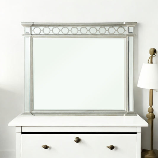 Ornate silver dresser mirror with decorative circle detail
