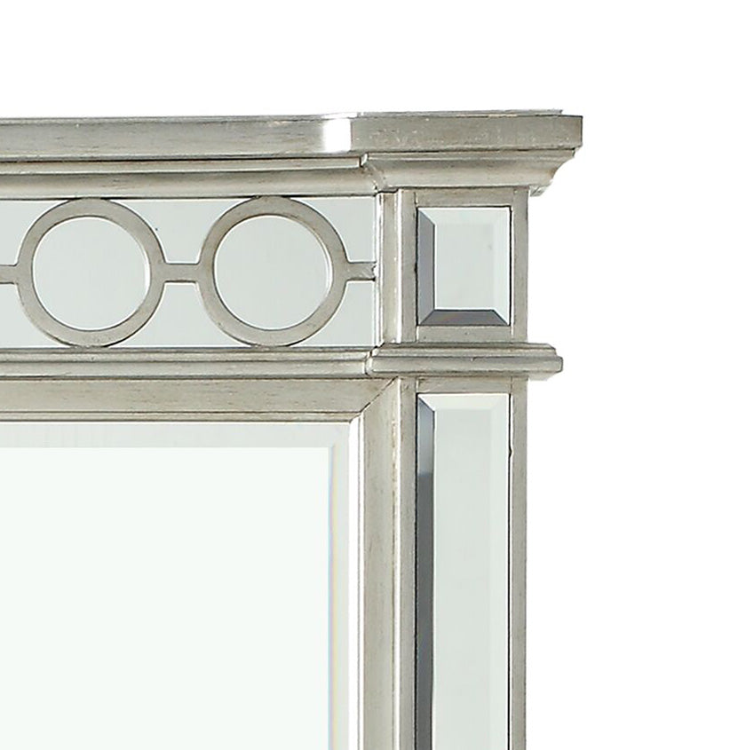 Silver framed accent mirror with circular geometric pattern