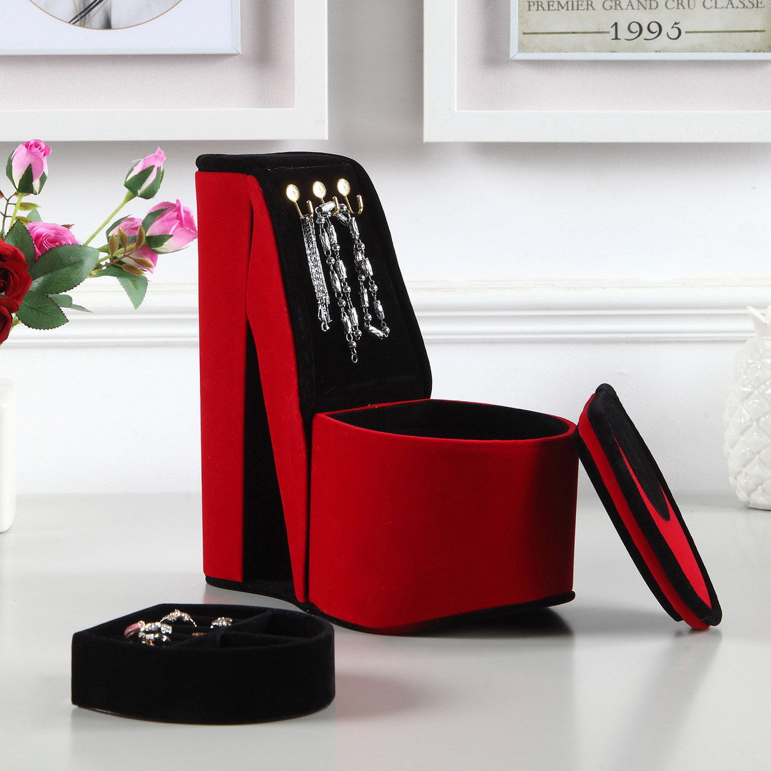 Red velvet high heel jewelry box with silver bracelets displayed