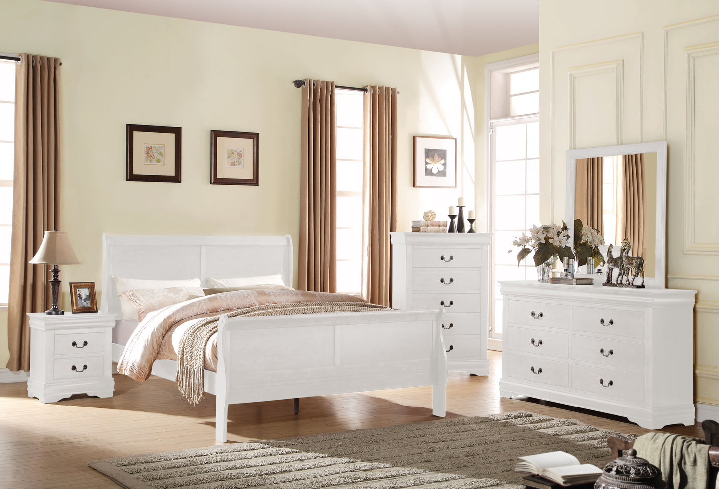 White sleigh bed with ornate detailing and plush bedding