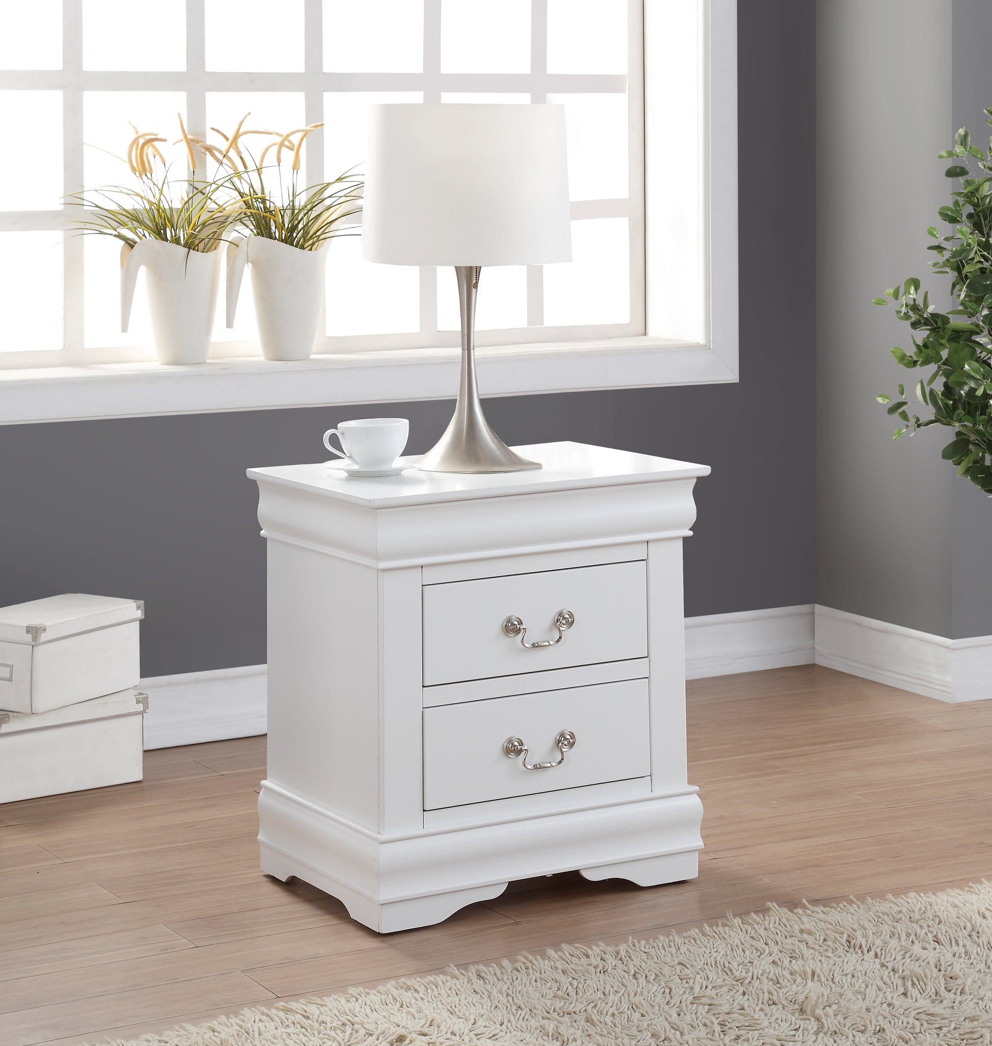 Elegant white nightstand with two drawers and ornate silver handles