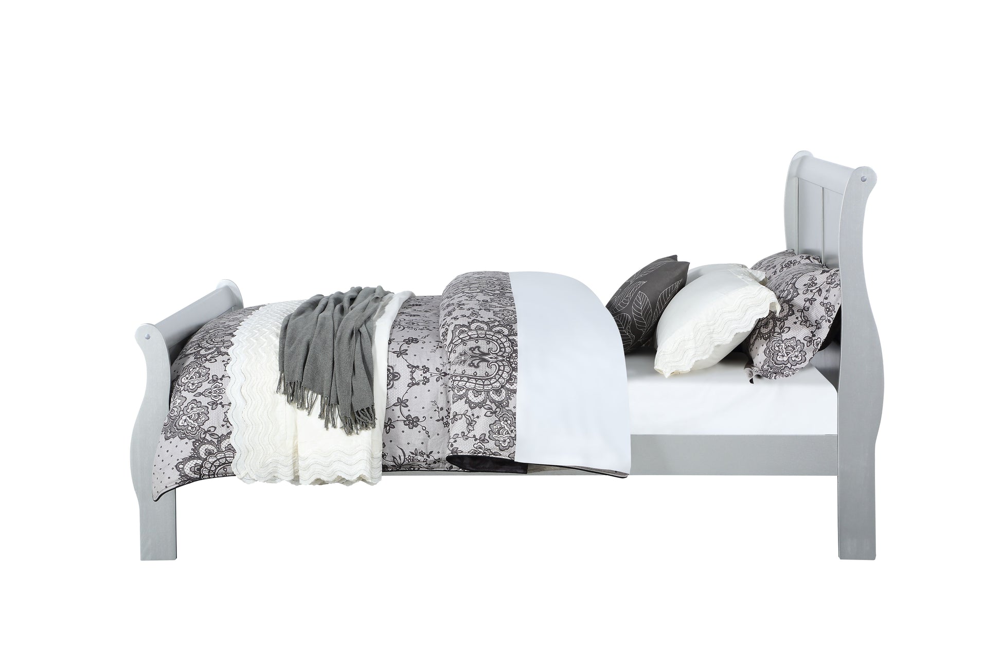 Grey sleigh bed frame with detailed floral bedding and a cozy throw blanket