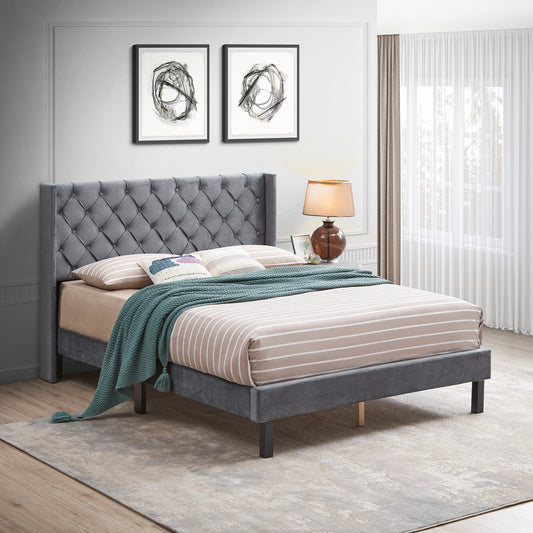 Gray velvet tufted wingback bed frame with a queen mattress and striped bedding