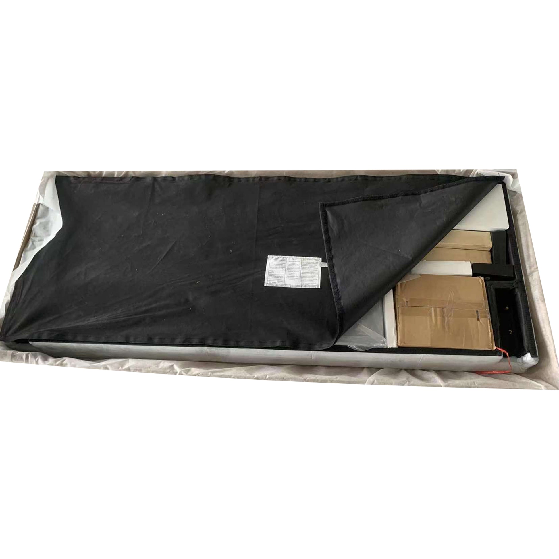 Black velvet upholstered headboard in protective packaging
