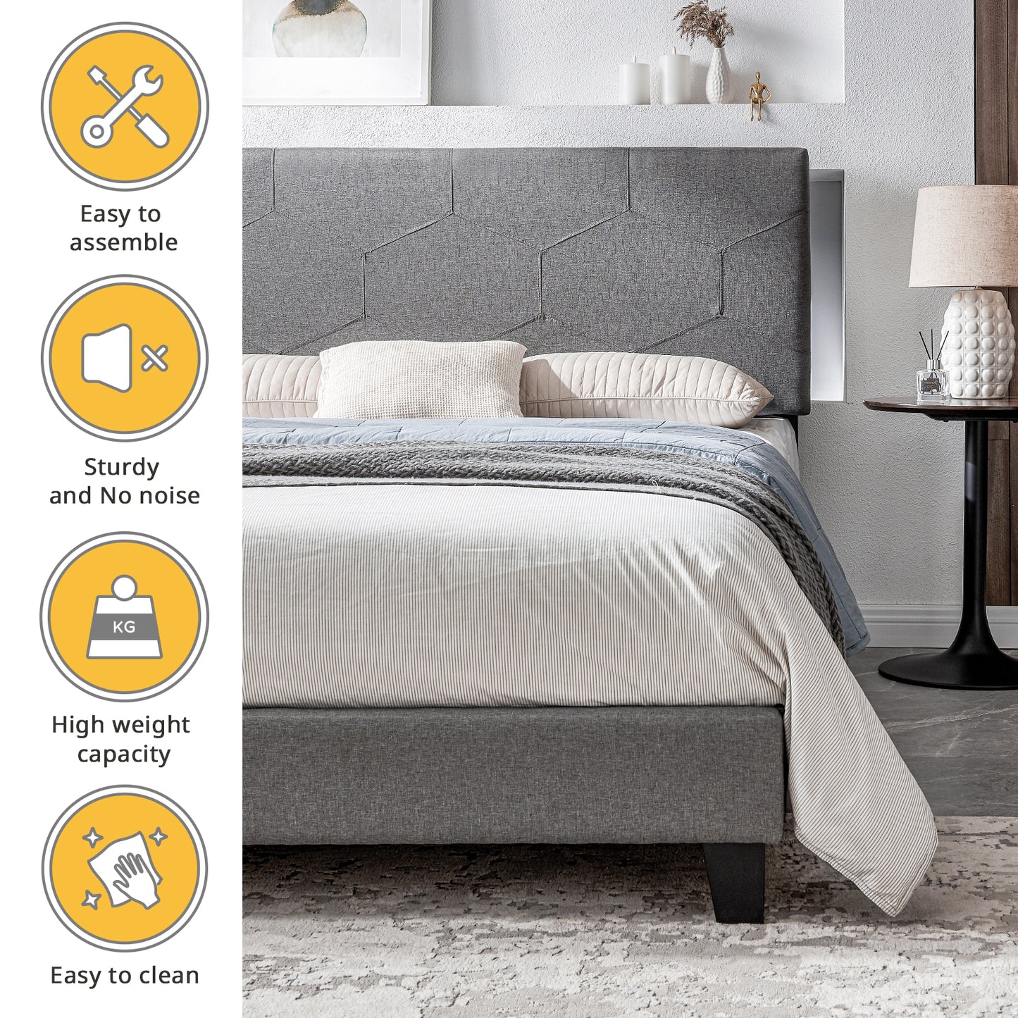 Gray upholstered platform bed with hexagonal headboard pattern and striped duvet