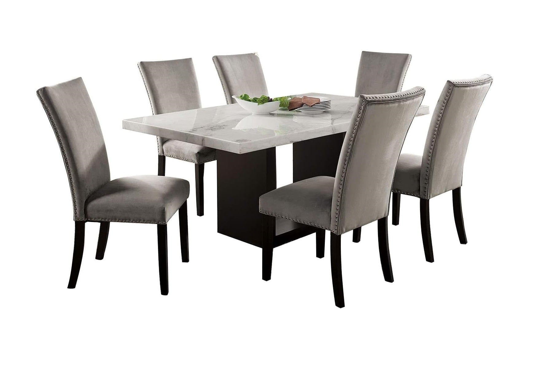 Gray velvet tufted dining chairs around a marbletop rectangular dining table