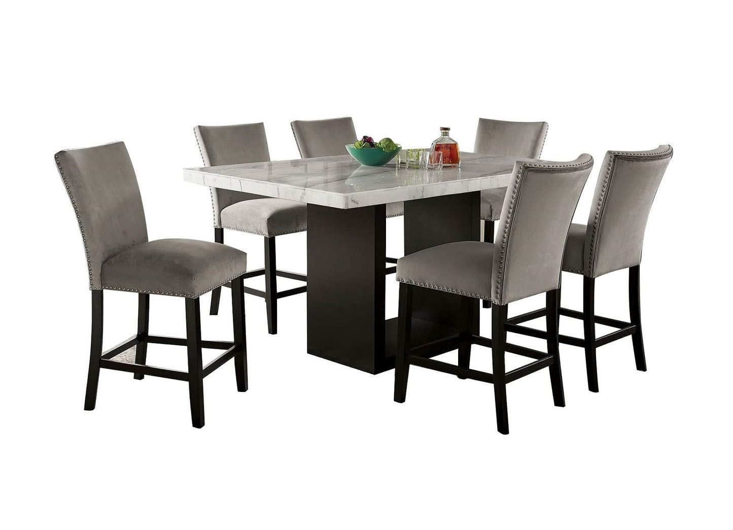 Gray velvet counter stools with silver nailhead trim around marble dining table