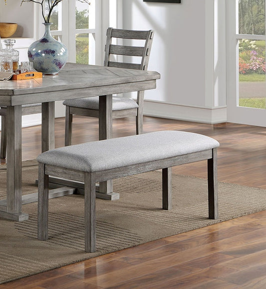 Upholstered dining bench with gray fabric seat and distressed wood frame