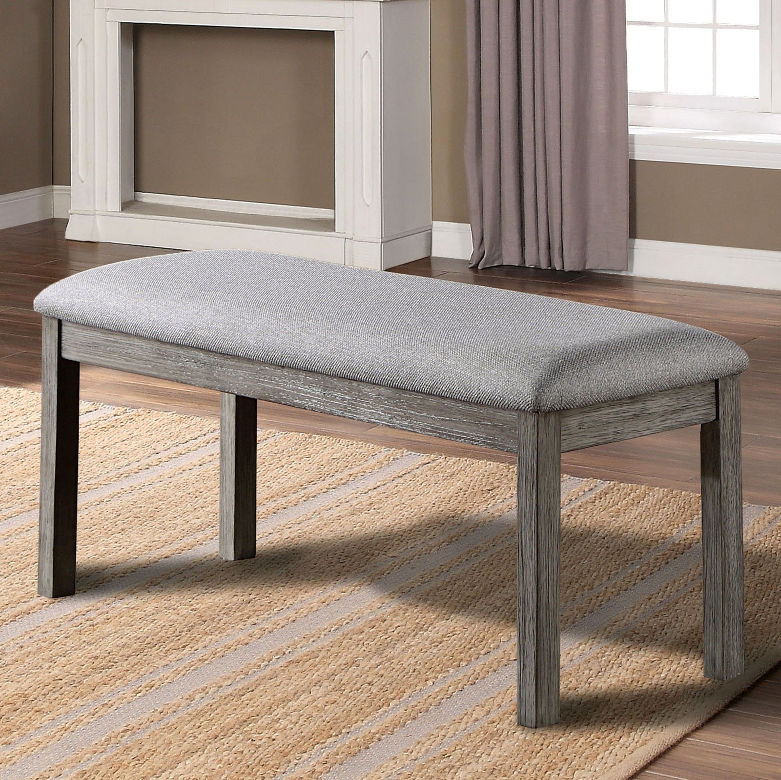 Gray upholstered bench with weathered wood legs