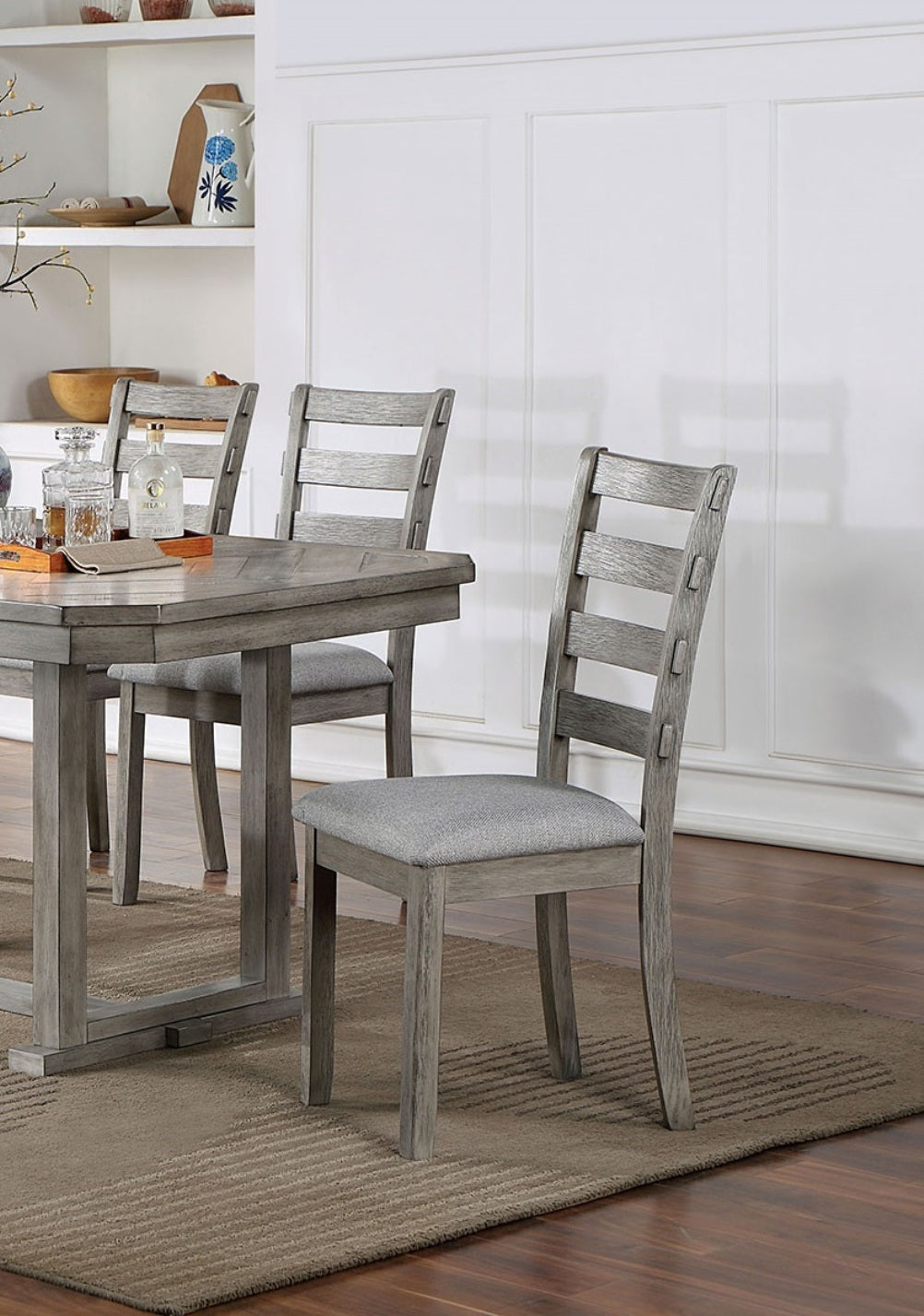 Gray wooden dining chair with upholstered seat and ladder back detail