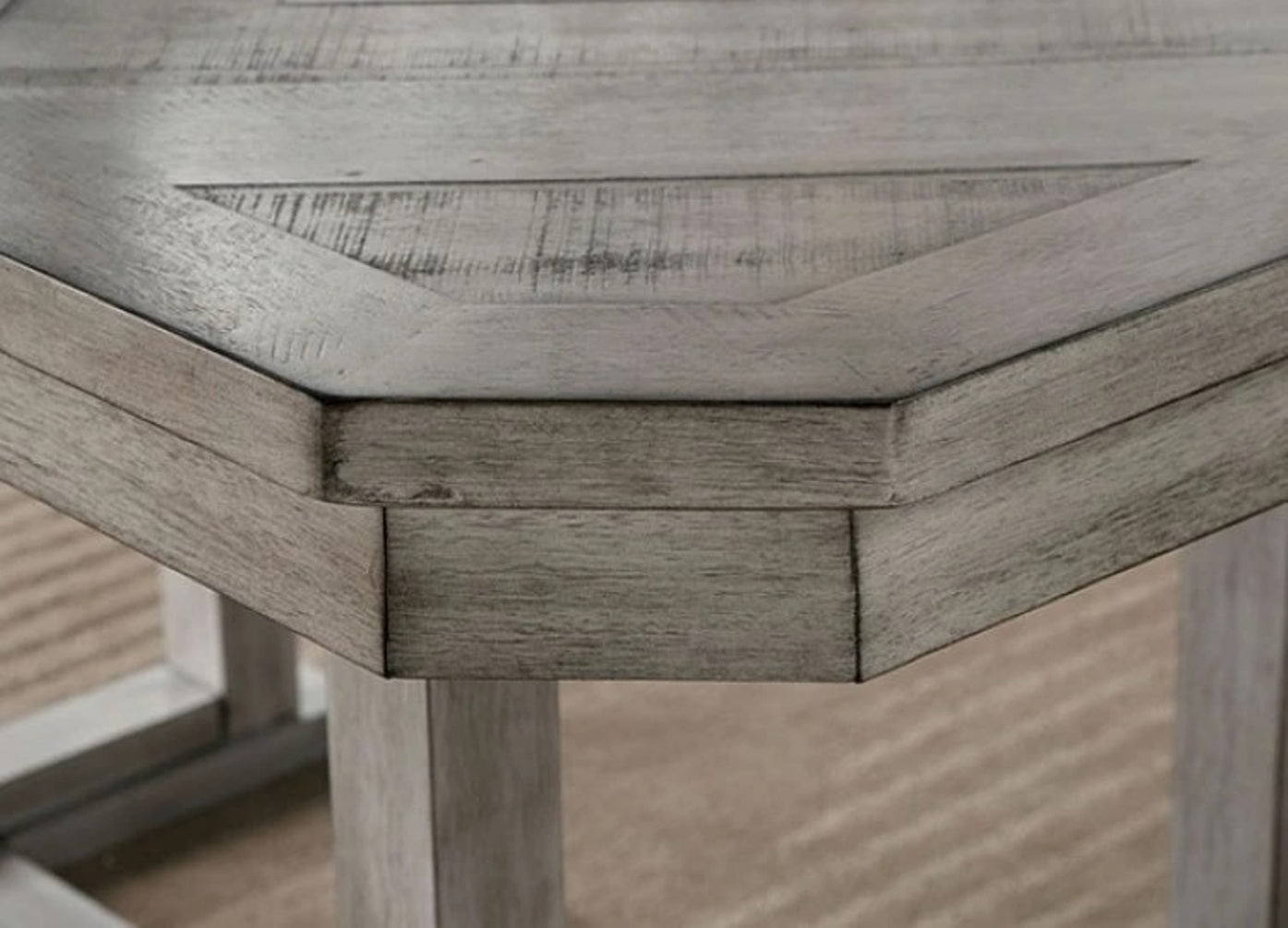 Distressed grey wood hexagonal table detail with angled planks