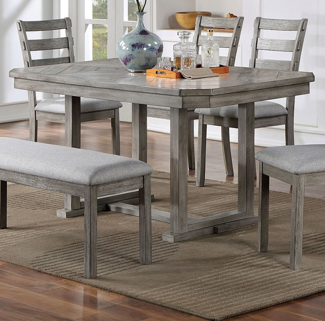 Gray wood dining table with upholstered bench and chairs