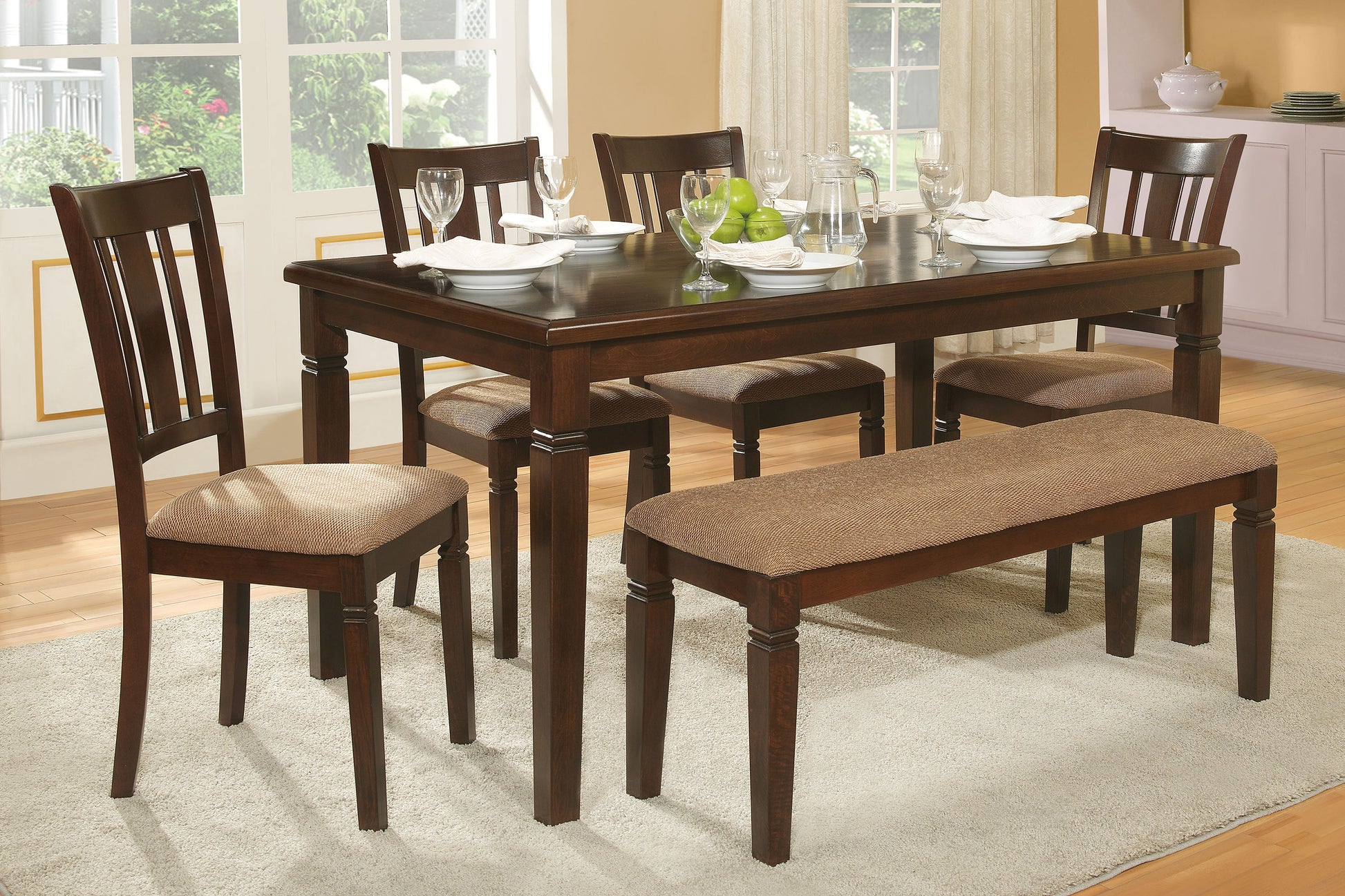 Dark wood dining table set with upholstered bench and chairs