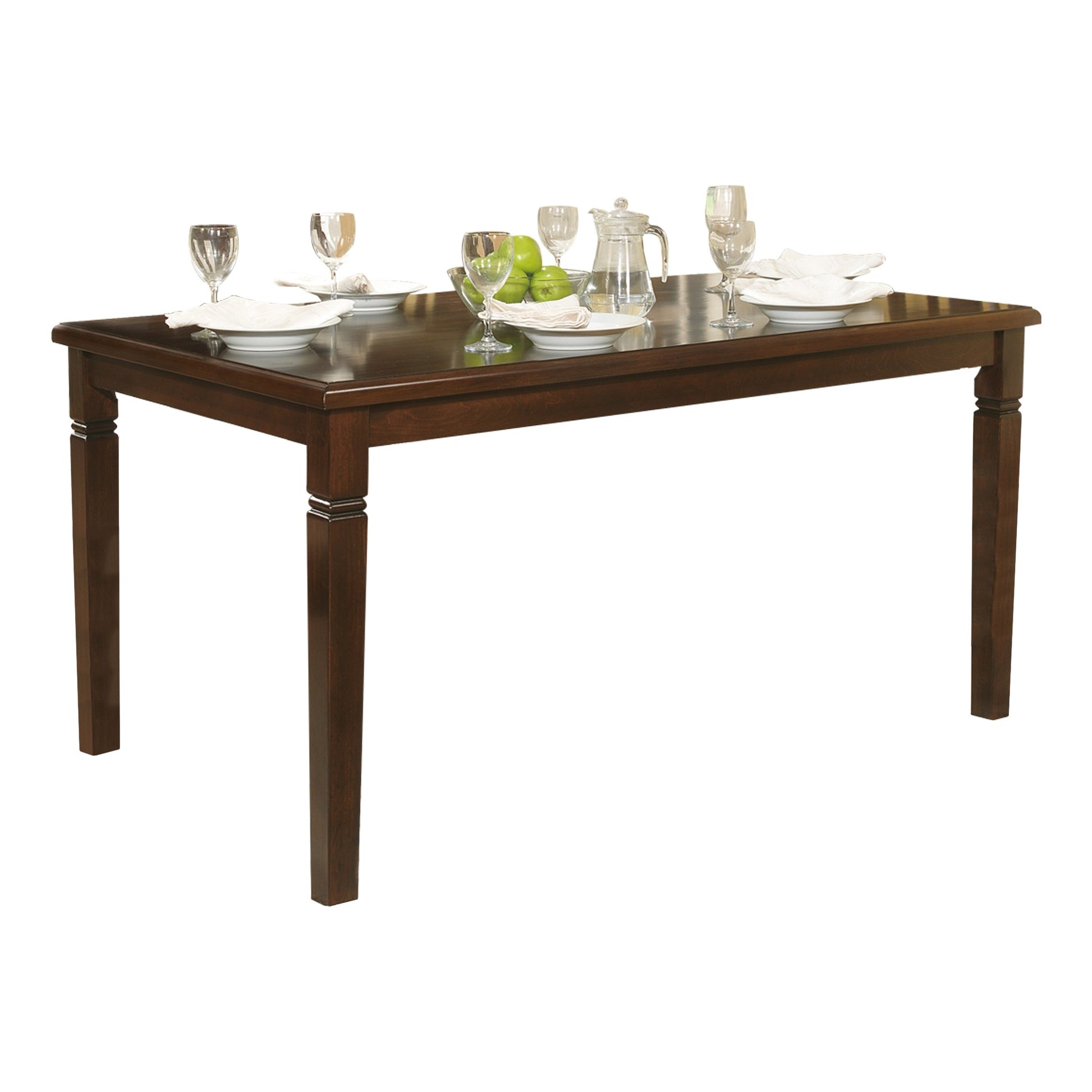 Dark brown wood dining table with place settings and green apples