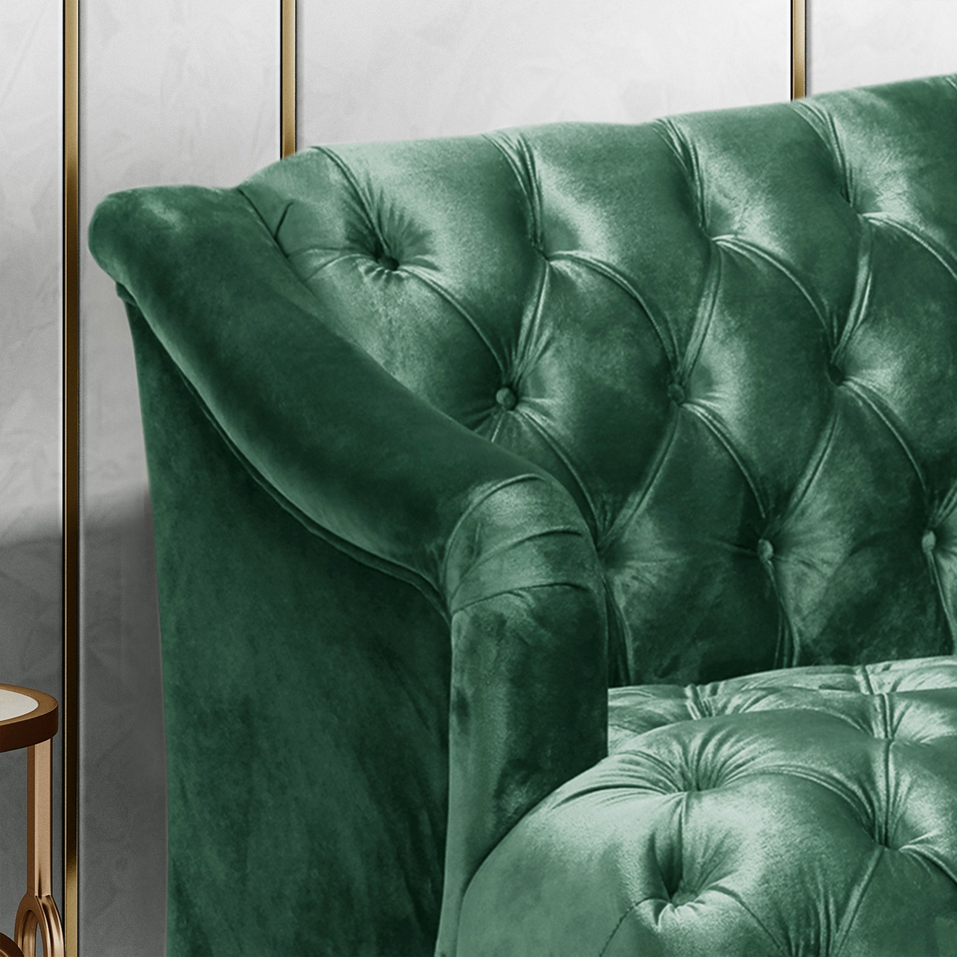 Deep green velvet chesterfield sofa with button tufting and rolled arms