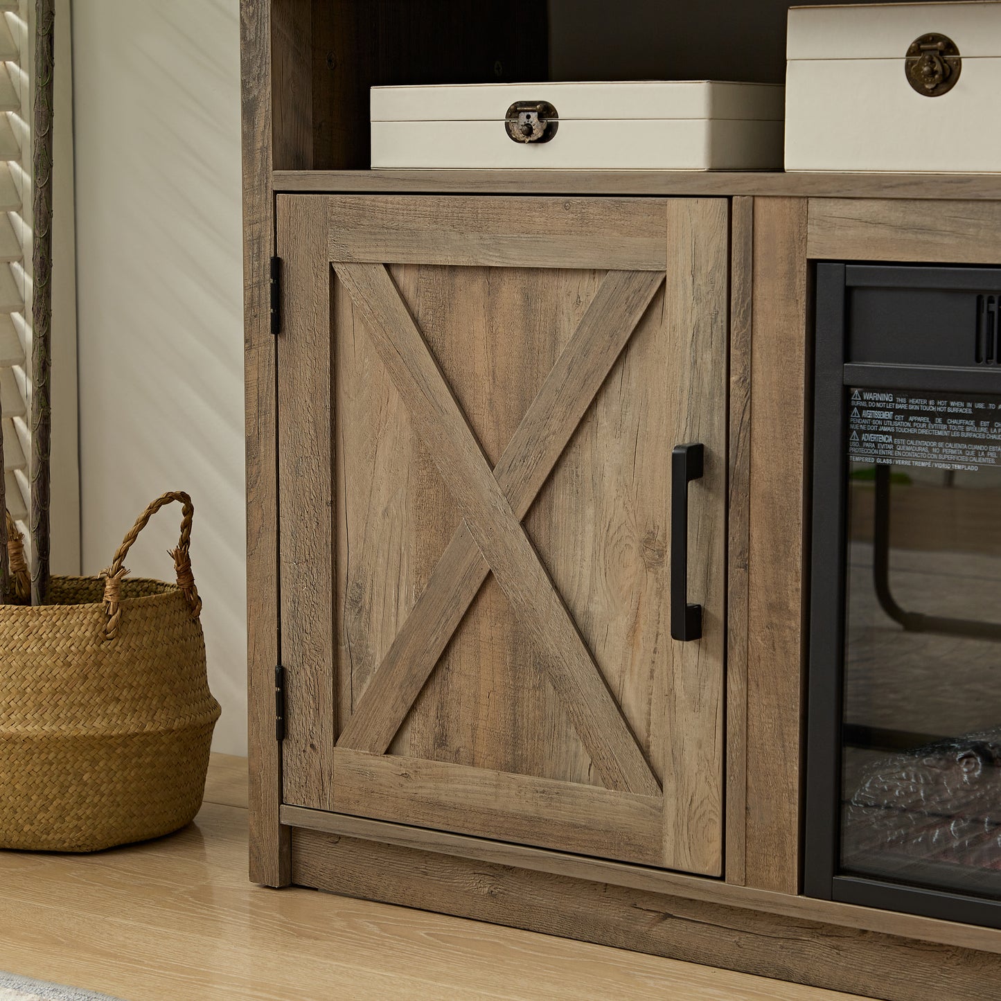 Barn door style cabinet with a black handle part of a rustic wood TV stand