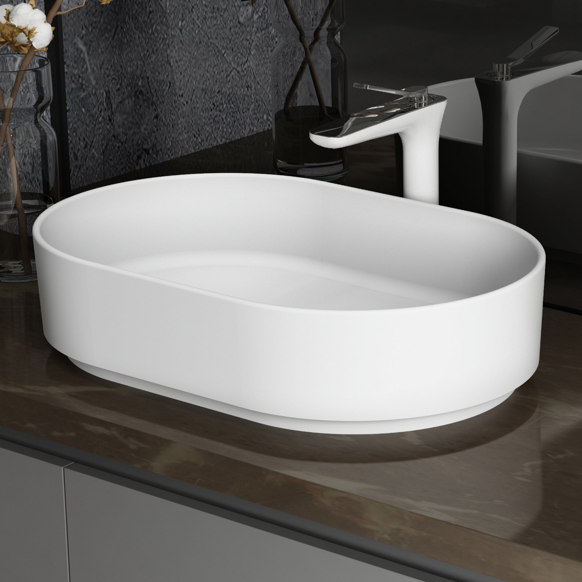White oval ceramic vessel sink with modern chrome faucet
