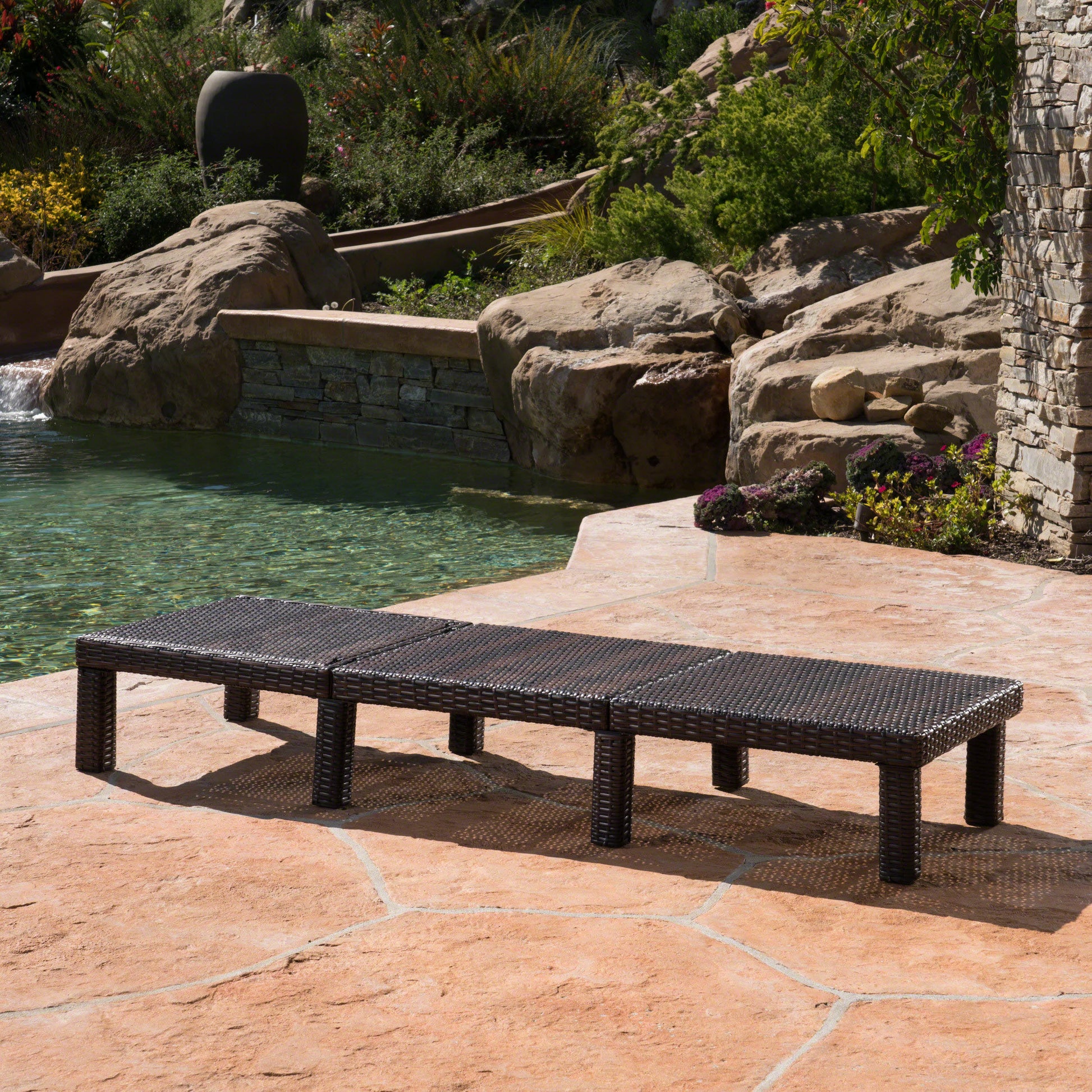 Dark brown wicker outdoor chaise lounge with three connected sections