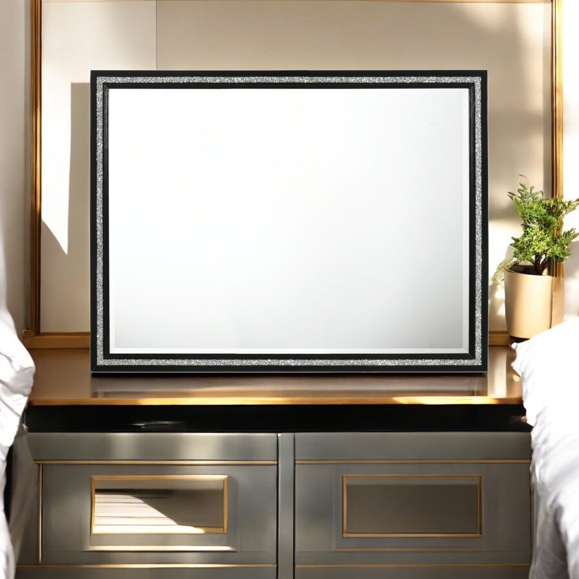 Decorative black mirror with sparkly silver trim on dresser