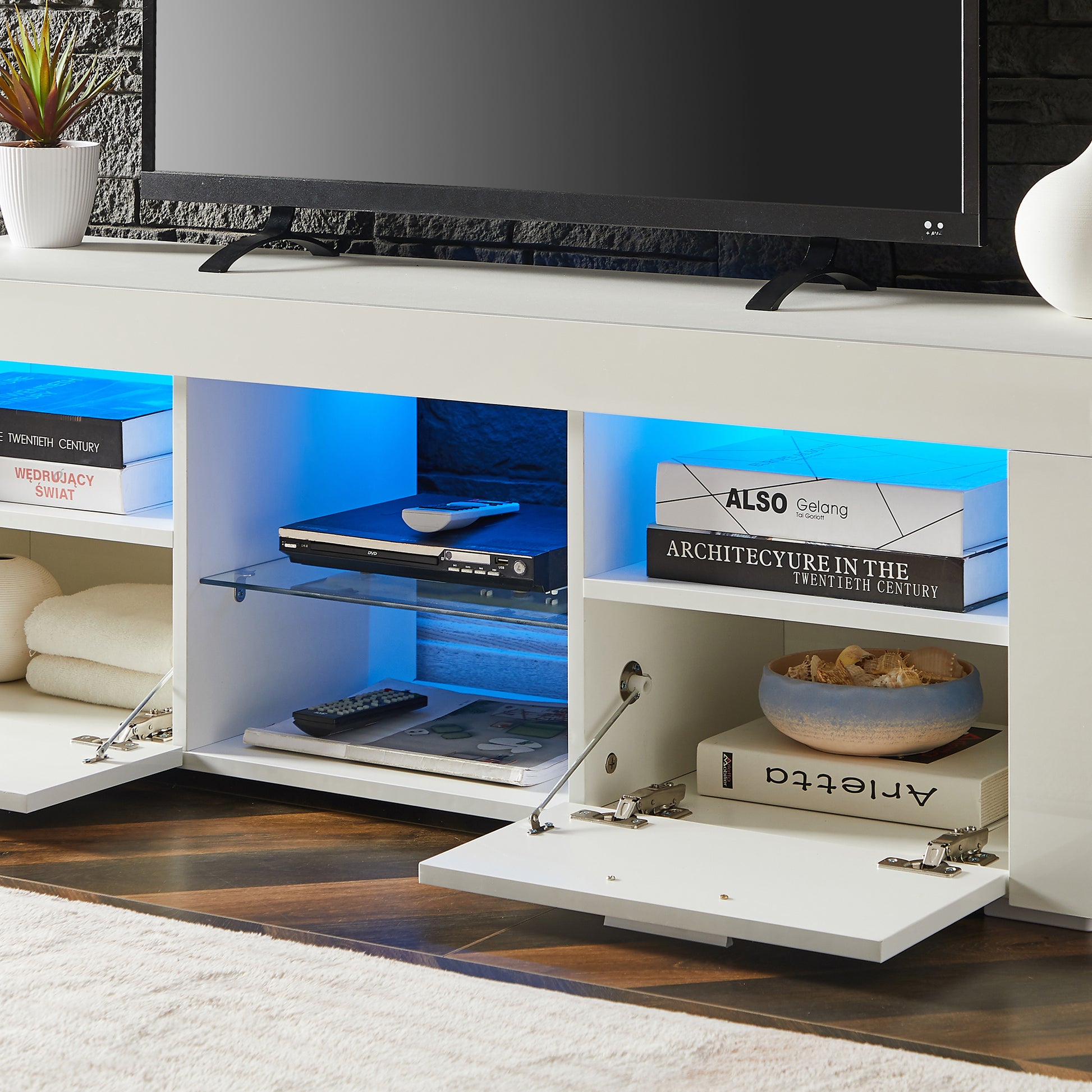 Modern white TV stand with blue LED lights featuring shelves and cabinets for media storage