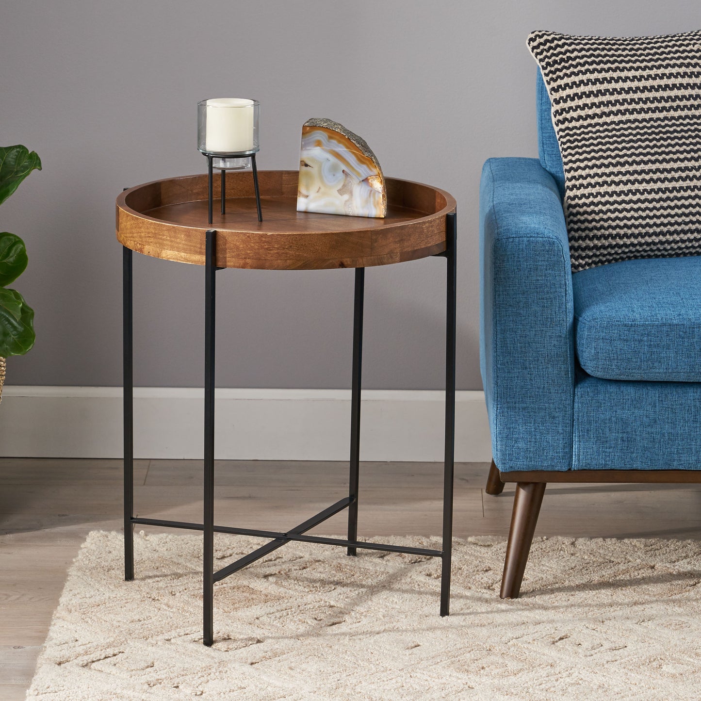 Round wooden tray table with black metal legs perfect for small spaces