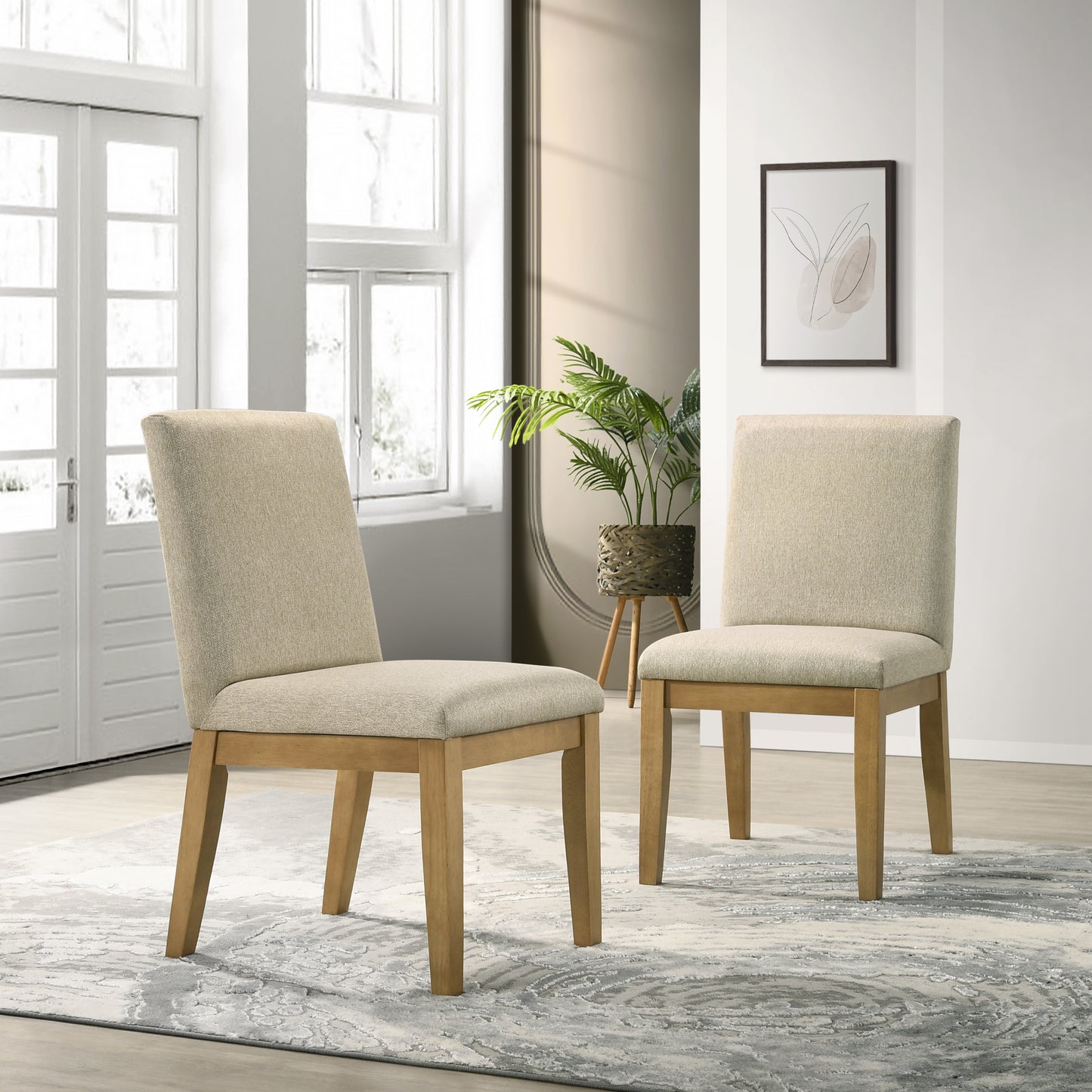 Two beige upholstered dining chairs with natural wood legs in a modern dining room setting